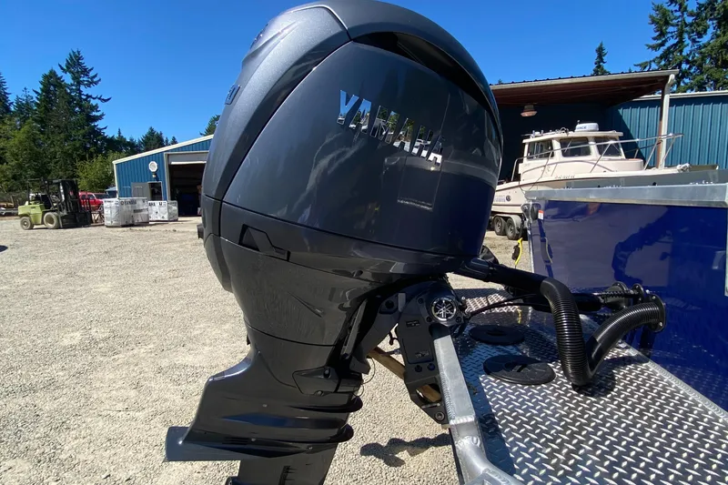 Slide: The Image of 2025 Hewescraft 190 Sea Runner HT with Yamaha outboard motor in a boatyard setting. - 13