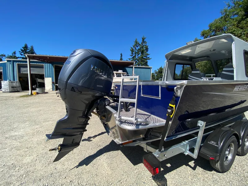Slide: The Image of 2025 Hewescraft 190 Sea Runner HT with Yamaha outboard motor, parked outdoors. - 9