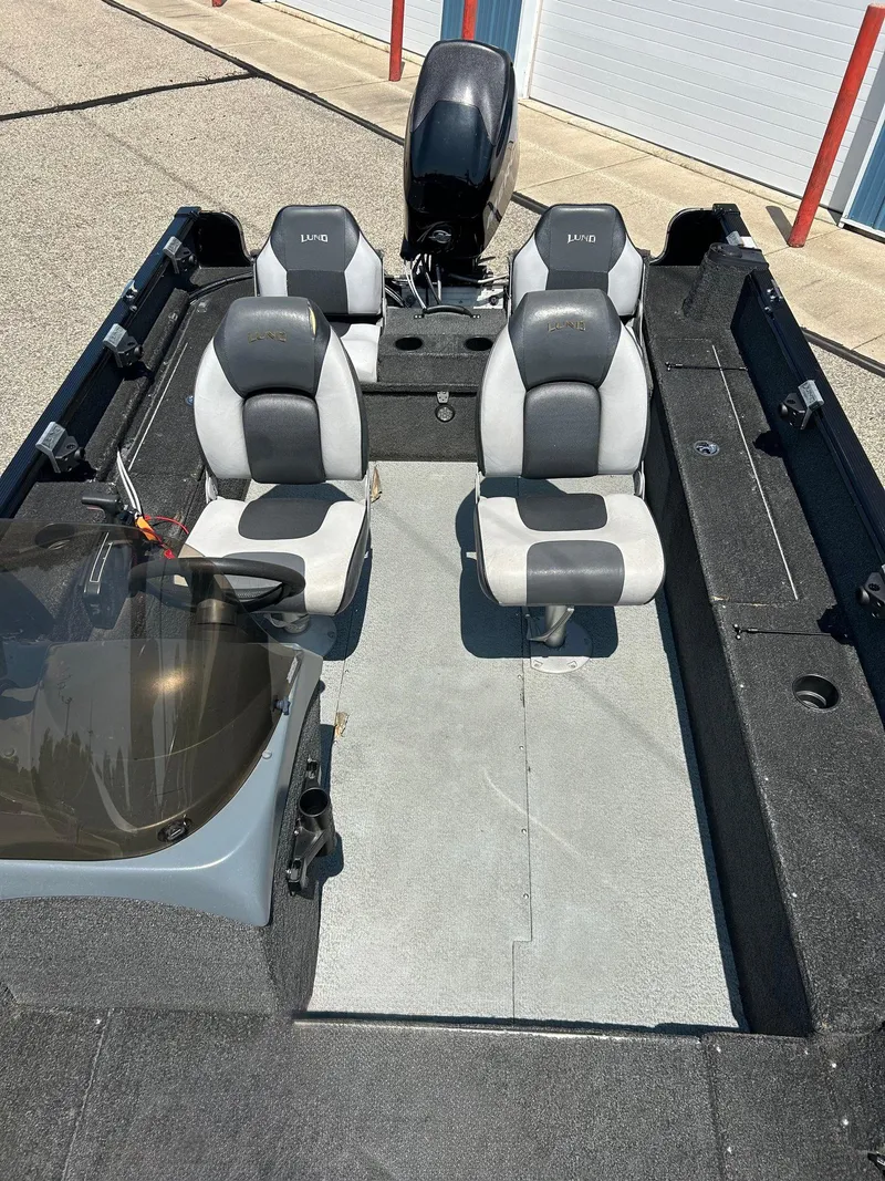 Slide: The Image of 2014 Lund 1625 Rebel XL SS boat interior with two seats and steering console. - 11