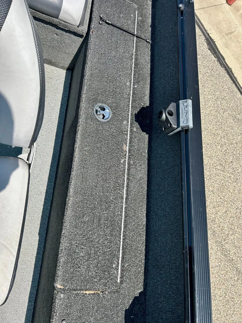 Slide: The Image of 2014 Lund 1625 Rebel XL SS boat interior with carpeted flooring and seating. - 13