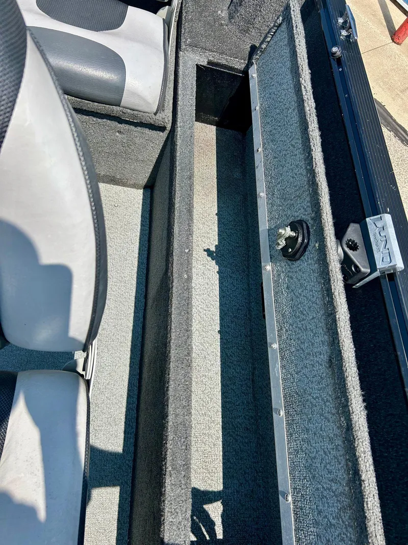 Slide: The Image of 2014 Lund 1625 Rebel XL SS boat interior with open storage compartment. - 14