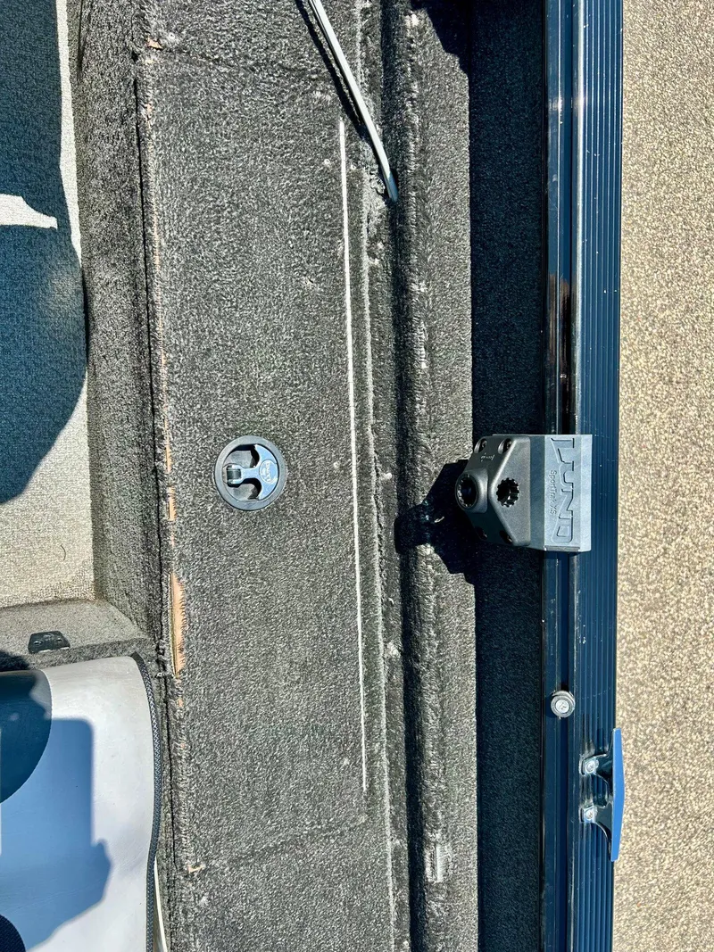 Slide: The Image of 2014 Lund 1625 Rebel XL SS boat interior with carpet and hardware details. - 15