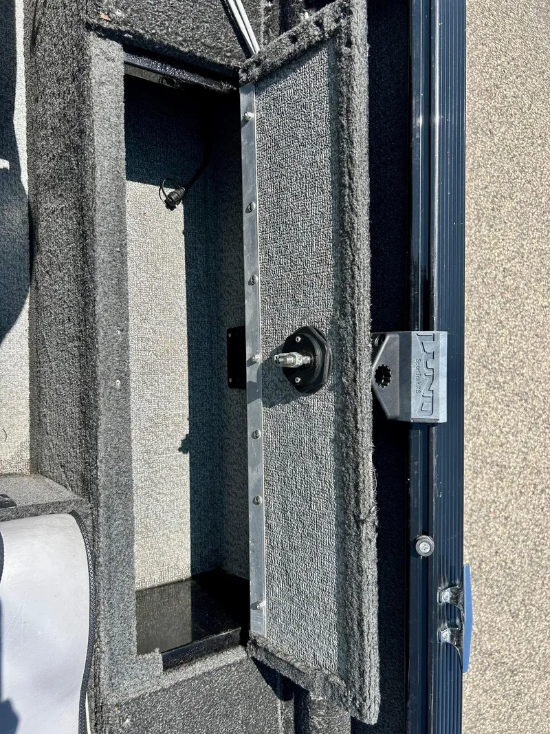 Slide: The Image of Open storage compartment in a 2014 Lund 1625 Rebel XL SS boat. - 16