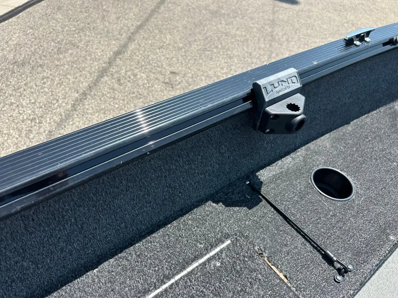 Slide: The Image of 2014 Lund 1625 Rebel XL SS boat interior with rod holder and carpeted surface. - 20