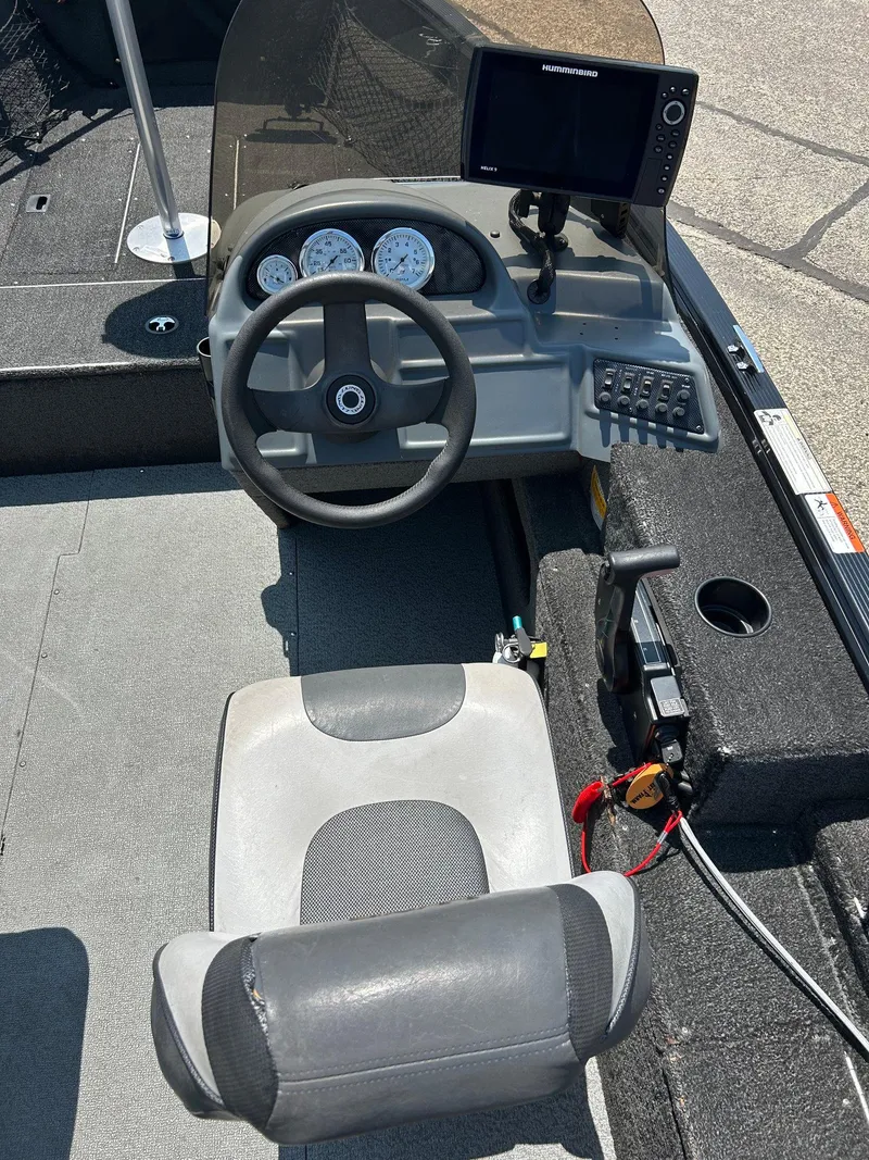 Slide: The Image of 2014 Lund 1625 Rebel XL SS boat cockpit with steering wheel and control panel. - 23
