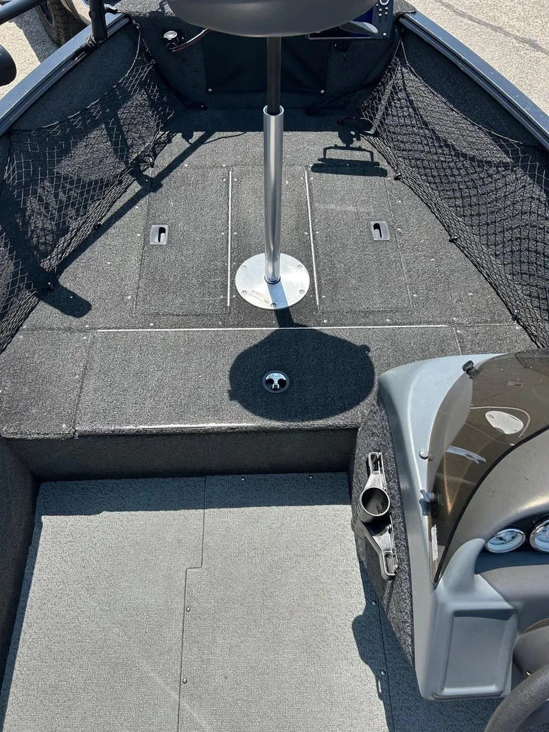 Slide: The Image of 2014 Lund 1625 Rebel XL SS boat interior with seating and storage compartments. - 24