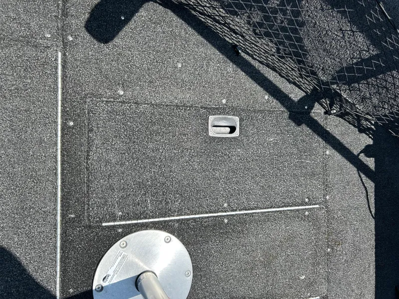 Slide: The Image of 2014 Lund 1625 Rebel XL SS boat deck with storage compartment and fishing net. - 26