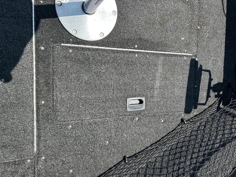 Slide: The Image of 2014 Lund 1625 Rebel XL SS boat deck with storage compartment and netting. - 28