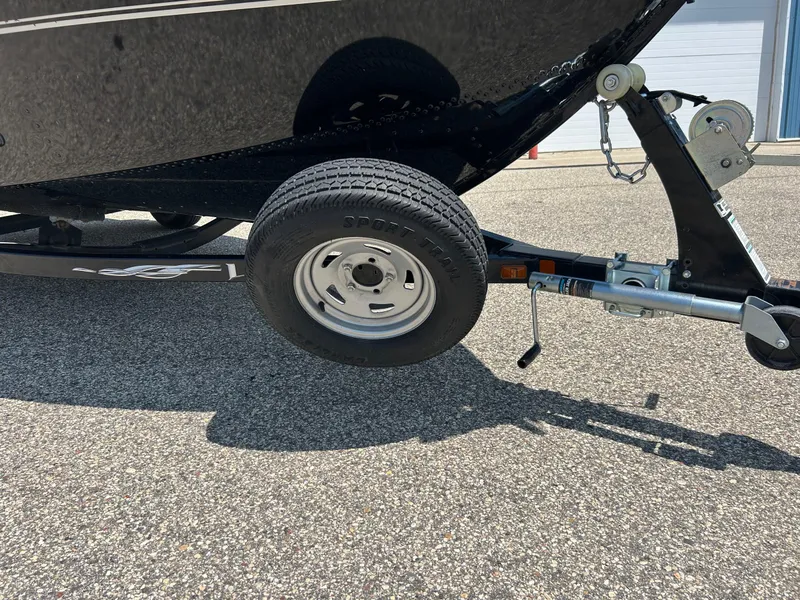 Slide: The Image of Trailer wheel and hitch of 2014 Lund 1625 Rebel XL SS boat on pavement. - 32