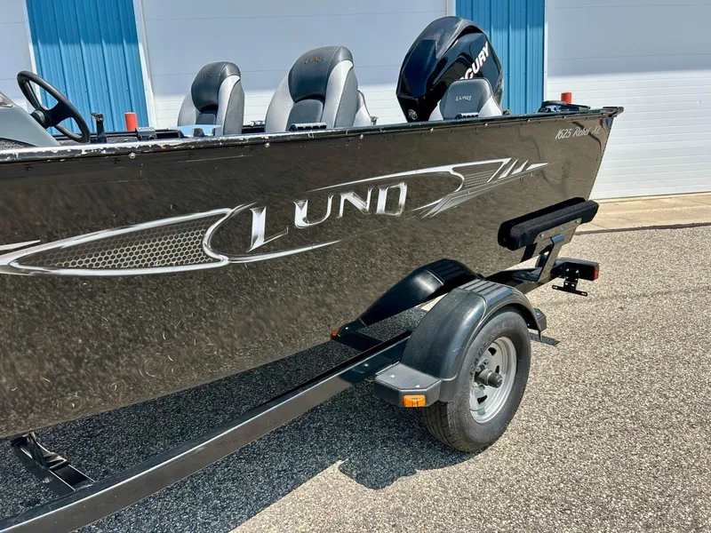 Slide: The Image of 2014 Lund 1625 Rebel XL SS boat on trailer, parked outdoors. - 34