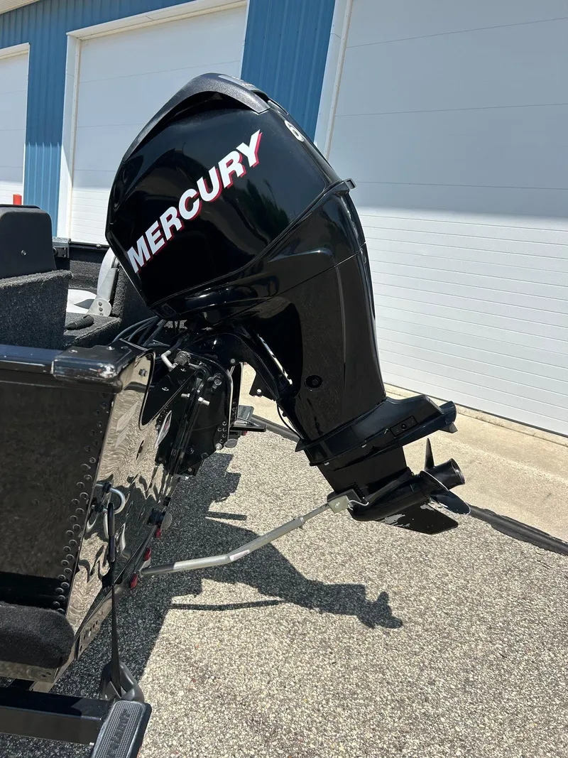 Slide: The Image of 2014 Lund 1625 Rebel XL SS with Mercury outboard motor in a sunny outdoor setting. - 36