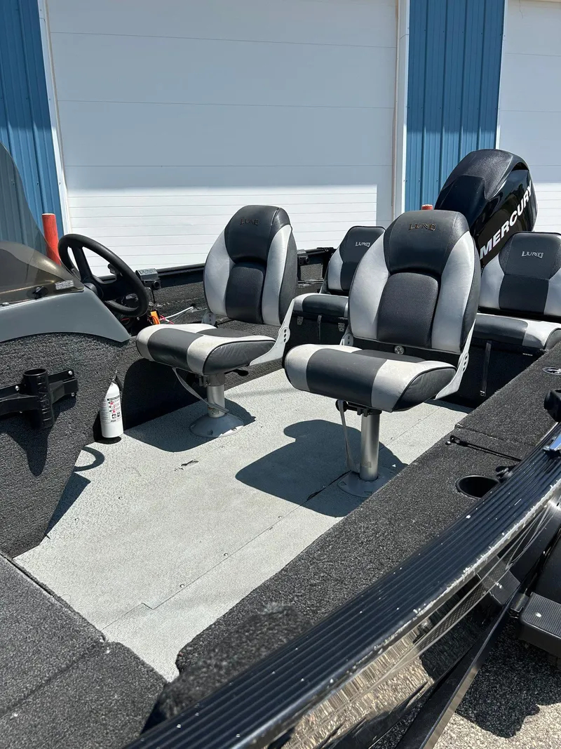 Slide: The Image of 2014 Lund 1625 Rebel XL SS boat interior with seating and Mercury engine. - 39