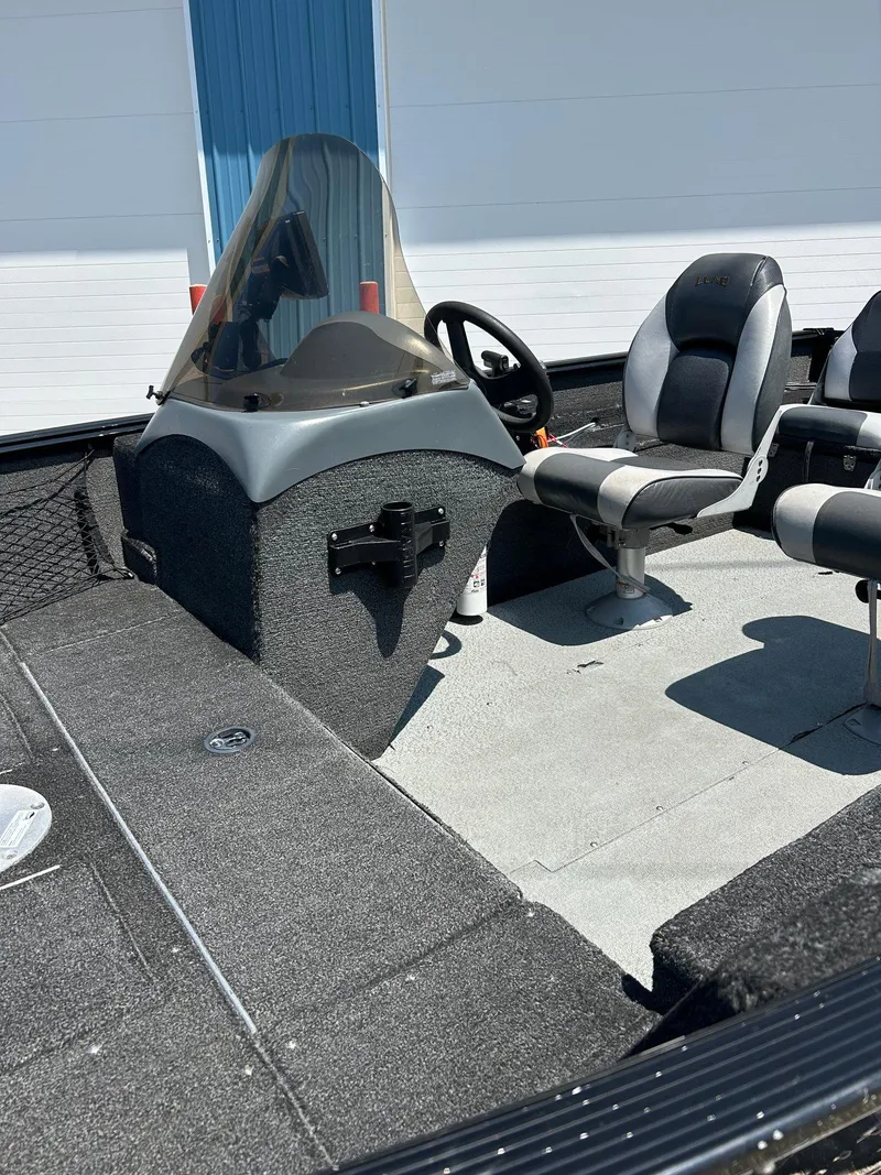 Slide: The Image of 2014 Lund 1625 Rebel XL SS boat interior with steering console and seating. - 40