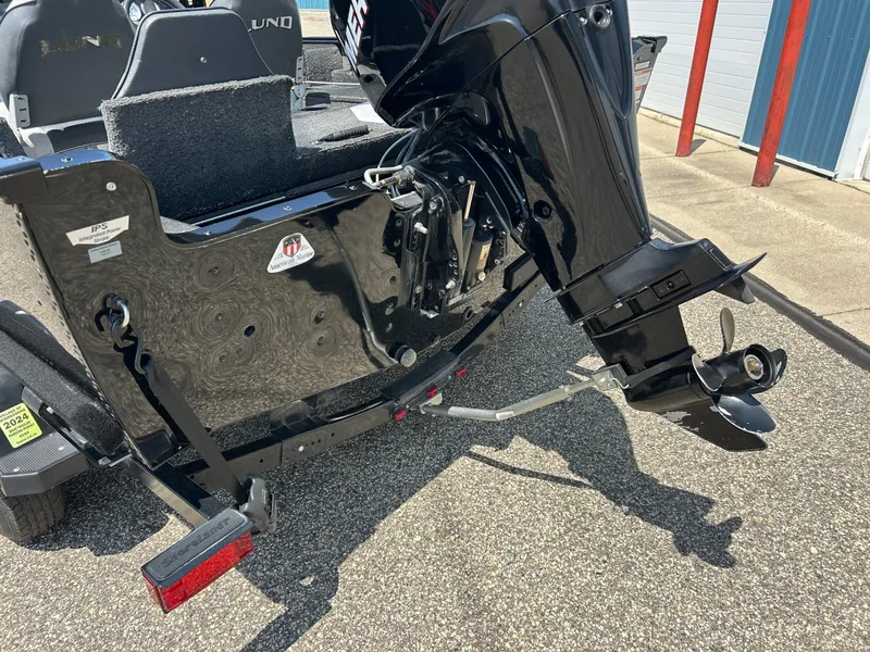 Slide: The Image of 2014 Lund 1625 Rebel XL SS boat with outboard motor and trailer, parked outdoors. - 41