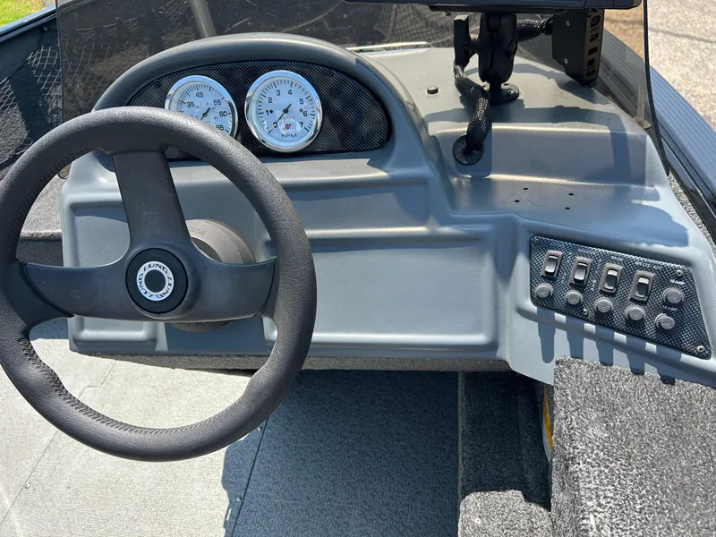 Slide: The Image of 2014 Lund 1625 Rebel XL SS boat dashboard with steering wheel and control panel. - 6