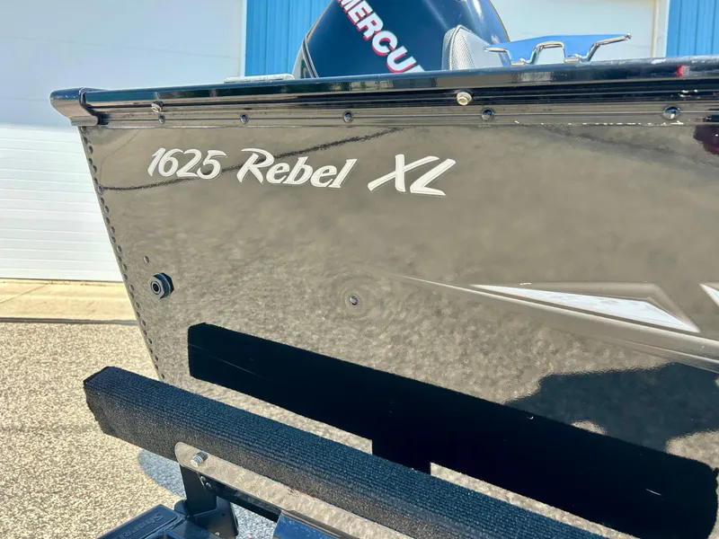Slide: The Image of 2014 Lund 1625 Rebel XL SS boat, close-up of model name on hull. - 8