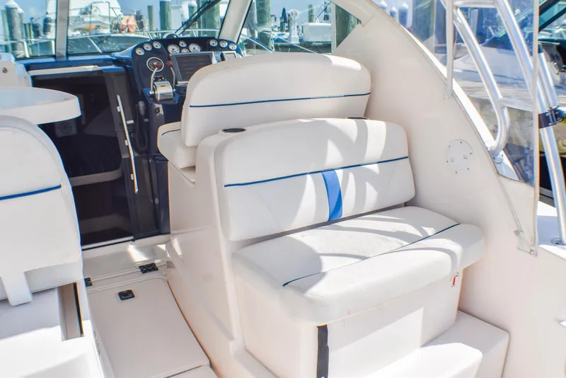 Slide: The Image of 2013 Tiara Yachts 3100 Open interior with white seating and control panel. - 12