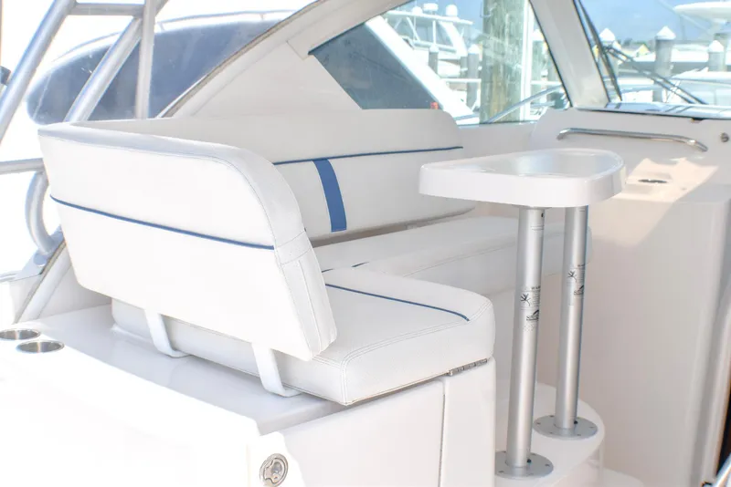 Slide: The Image of 2013 Tiara Yachts 3100 Open interior with white seating and table. - 13
