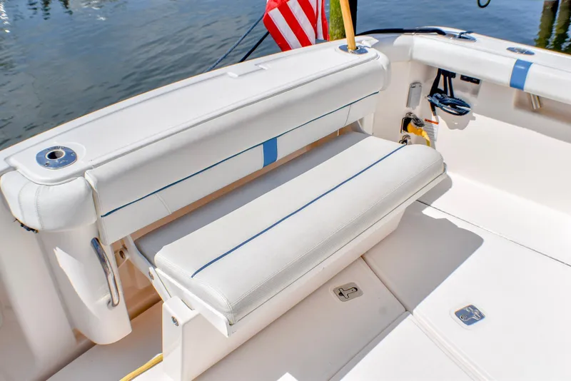 Slide: The Image of 2013 Tiara Yachts 3100 Open boat interior with white seating and American flag. - 15