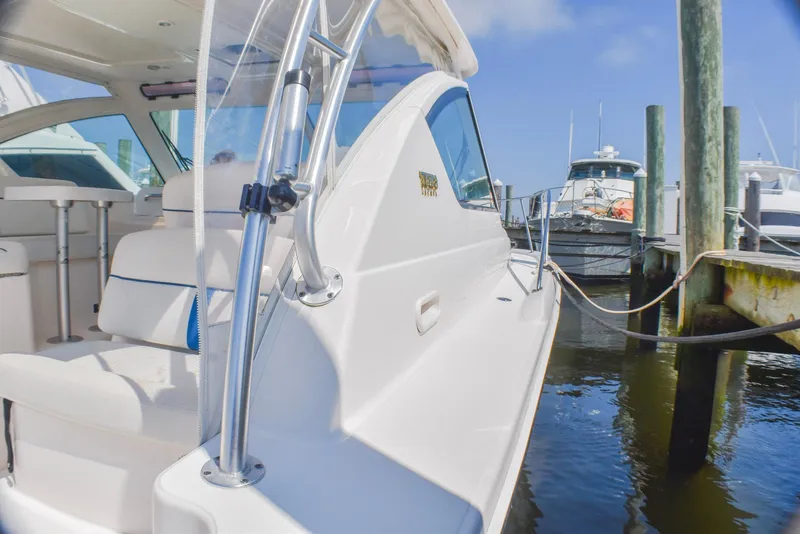 Slide: The Image of 2013 Tiara Yachts 3100 Open docked, showcasing sleek design and comfortable seating. - 16