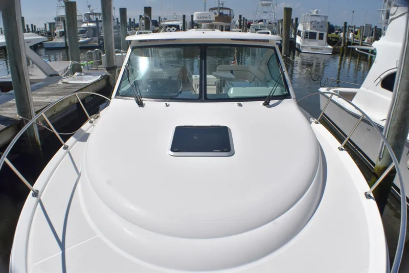 Slide: The Image of 2013 Tiara Yachts 3100 Open docked at marina, front view. - 17
