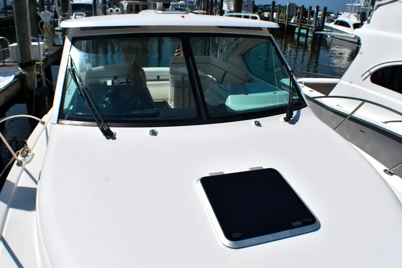 Slide: The Image of 2013 Tiara Yachts 3100 Open docked, showcasing sleek design and spacious cockpit. - 19