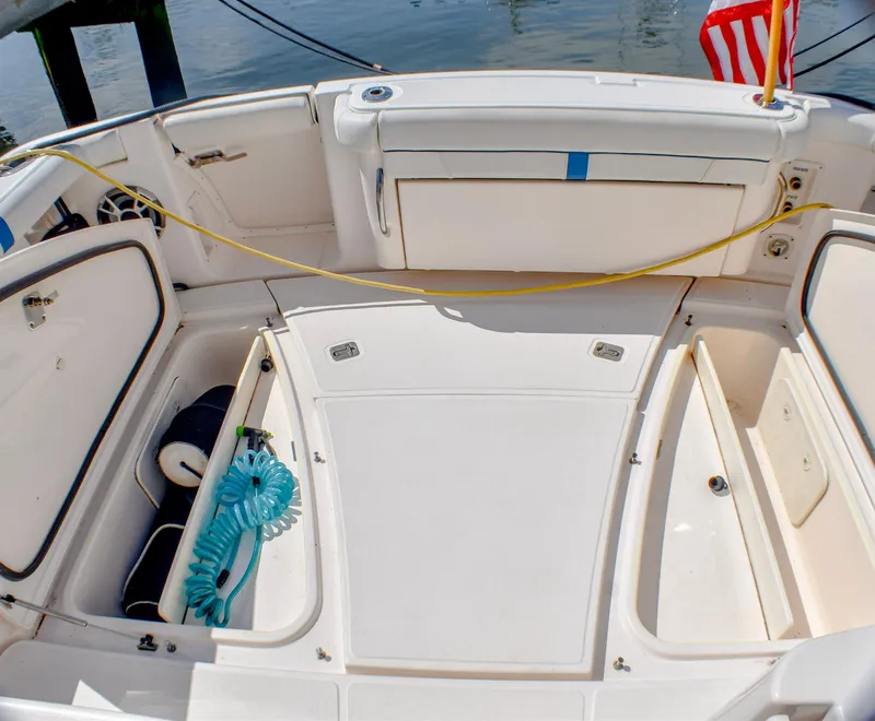 Slide: The Image of 2013 Tiara Yachts 3100 Open boat deck with storage compartments and coiled hose. - 24