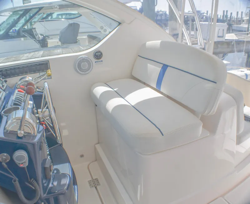 Slide: The Image of 2013 Tiara Yachts 3100 Open interior with white seating and control panel. - 27