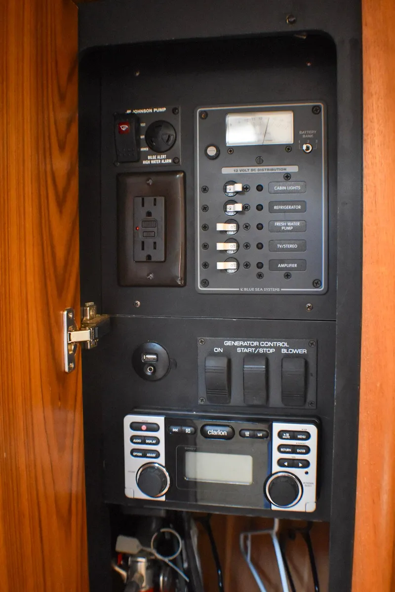 Slide: The Image of Control panel of a 2013 Tiara Yachts 3100 Open, featuring switches and a Clarion audio system. - 29