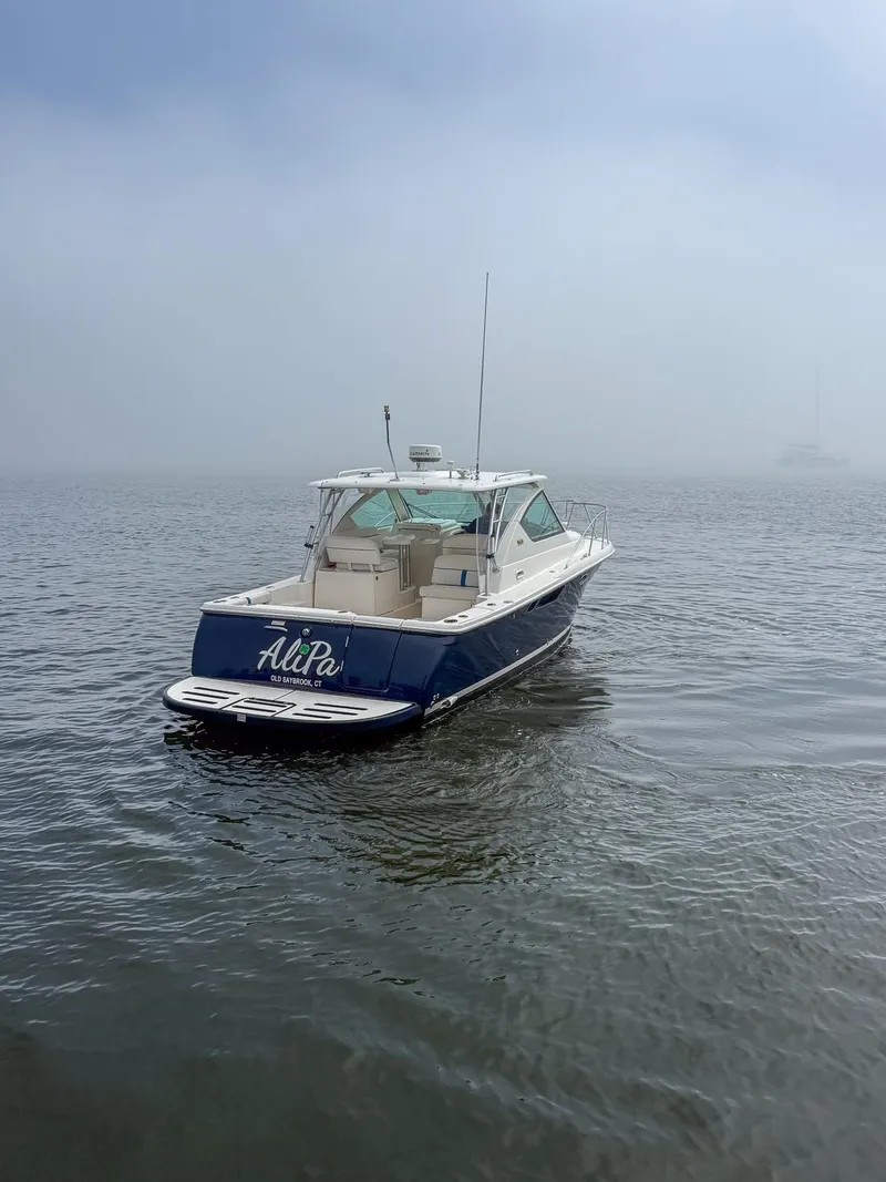 Slide: The Image of 2013 Tiara Yachts 3100 Open boat on misty water, rear view. - 3