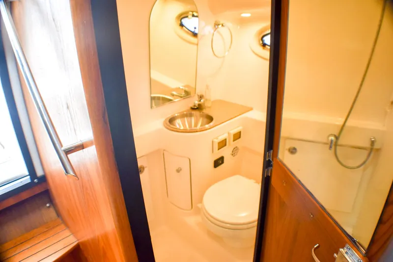 Slide: The Image of 2013 Tiara Yachts 3100 Open bathroom with sink, toilet, and shower. - 30