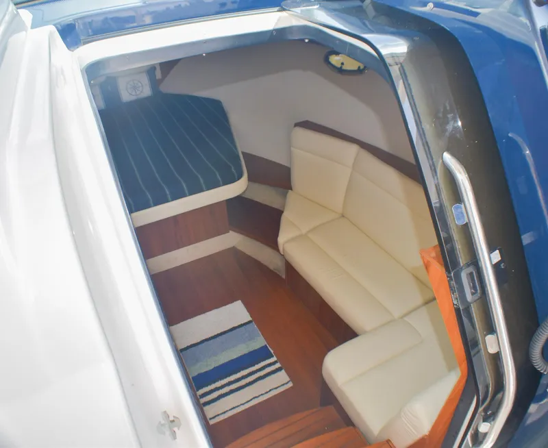 Slide: The Image of Interior of 2013 Tiara Yachts 3100 Open, featuring seating and striped rug. - 34