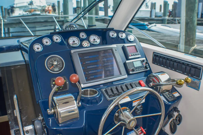 Slide: The Image of Control panel of a 2013 Tiara Yachts 3100 Open, featuring navigation and control instruments. - 35
