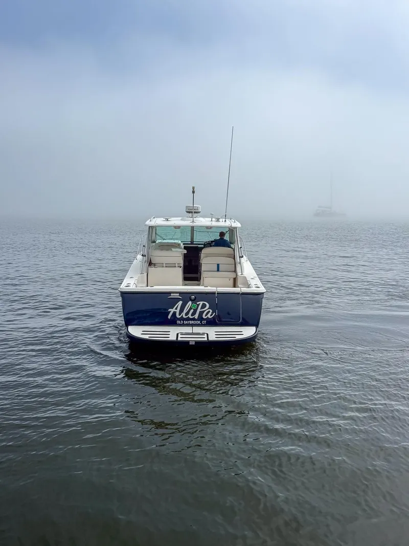 Slide: The Image of 2013 Tiara Yachts 3100 Open in foggy waters, rear view. - 5