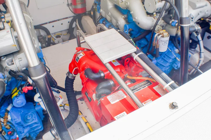 Slide: The Image of Engine compartment of 2013 Tiara Yachts 3100 Open, featuring vibrant red and blue components. - 8