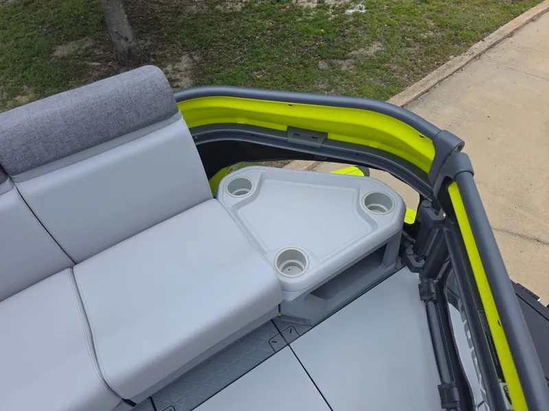 Slide: The Image of 2024 Sea-Doo Switch boat interior with gray seating and integrated cup holders. - 10