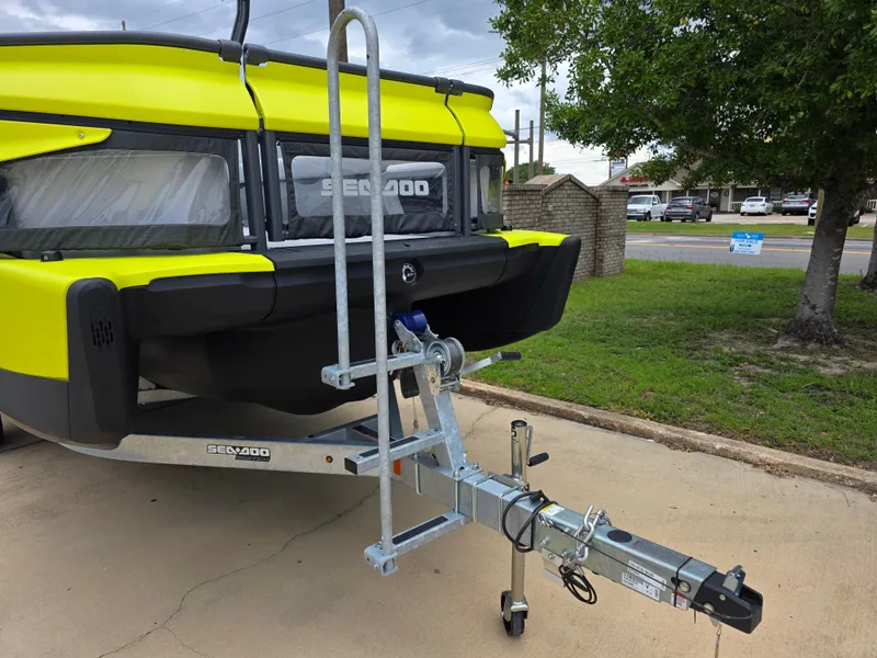 Slide: The Image of 2024 Sea-Doo Switch boat on trailer, vibrant yellow and black design, parked outdoors. - 12