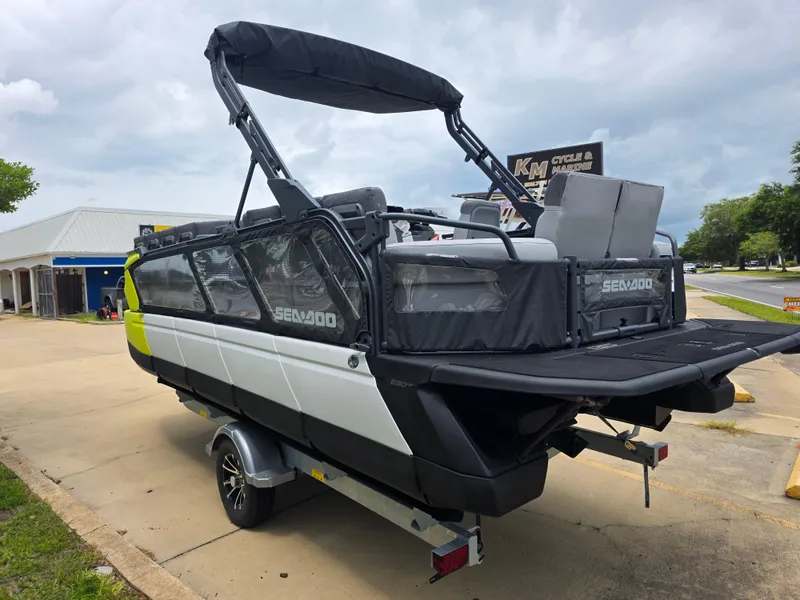 Slide: The Image of 2024 Sea-Doo Switch boat on trailer, parked outdoors, showcasing sleek design and modern features. - 4