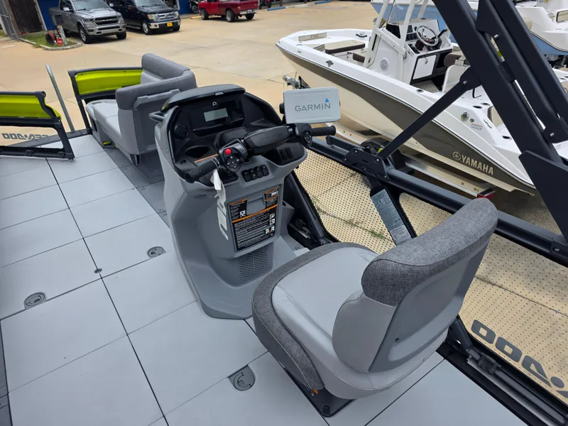 Slide: The Image of 2024 Sea-Doo Switch boat interior with Garmin navigation system and comfortable seating. - 6