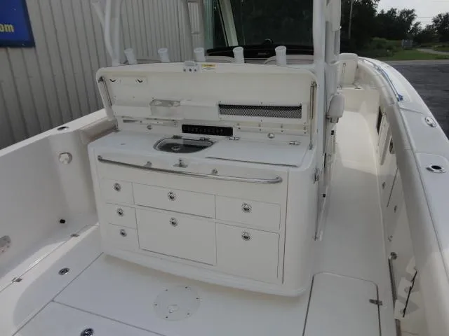 Slide: The Image of 2021 Boston Whaler 350 Outrage boat interior with storage and sink. - 11