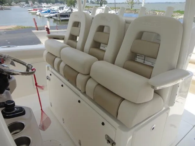 Slide: The Image of 2021 Boston Whaler 350 Outrage boat seats, beige upholstery, docked near marina. - 13