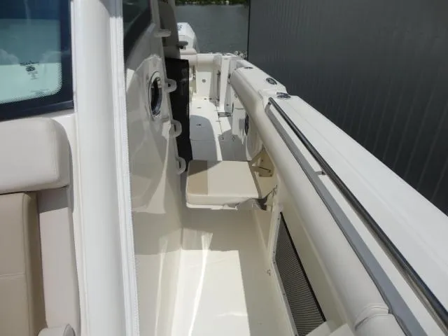 Slide: The Image of 2021 Boston Whaler 350 Outrage boat interior with seating and railing. - 15