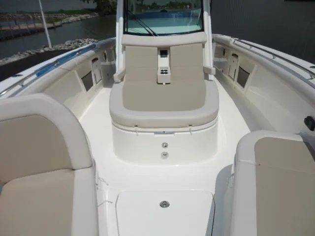 Slide: The Image of 2021 Boston Whaler 350 Outrage boat interior with beige seating and sleek design. - 17