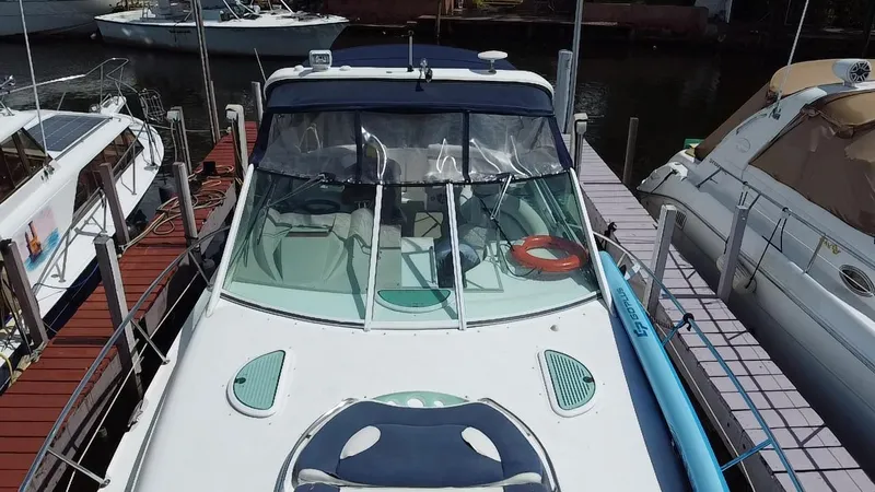 Slide: The Image of 2006 Doral 365 boat docked at marina, top view showing deck and windshield. - 11