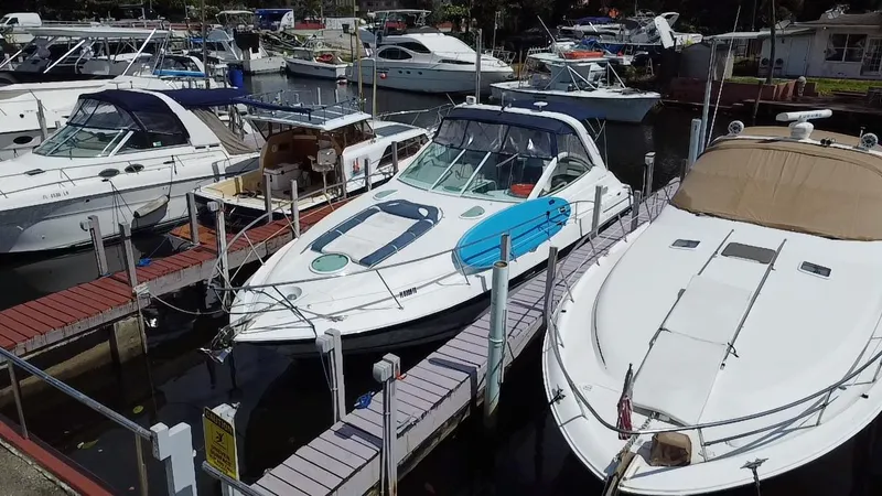 Slide: The Image of 2006 Doral 365 boat docked at a marina, surrounded by other vessels. - 12