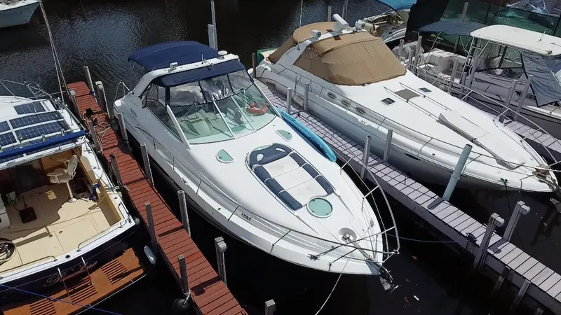 Slide: The Image of 2006 Doral 365 yacht docked among other boats in a marina. - 13