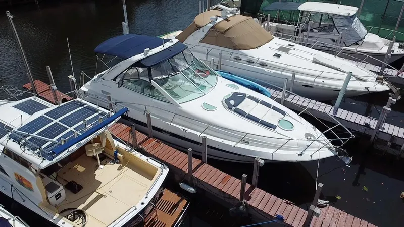 Slide: The Image of 2006 Doral 365 boat docked among other vessels at a marina. - 14