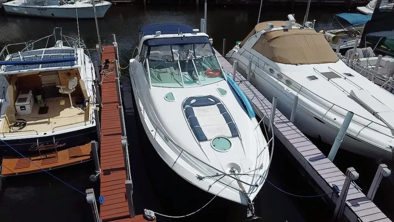 Slide: The Image of 2006 Doral 365 yacht docked between two boats at a marina. - 16