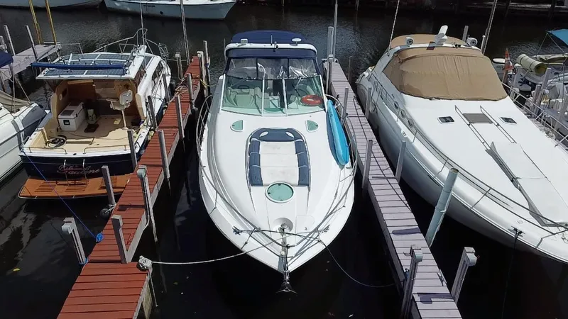 Slide: The Image of 2006 Doral 365 boat docked between two other boats at a marina. - 17