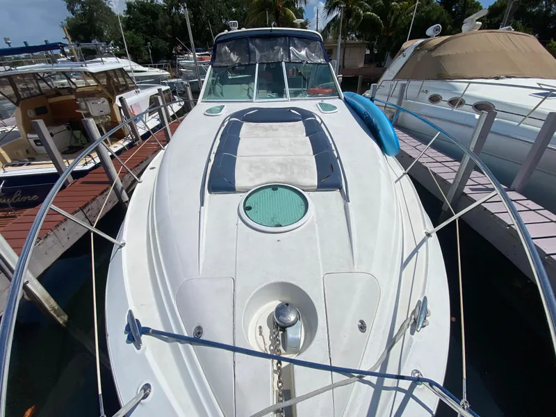 Slide: The Image of 2006 Doral 365 boat docked, featuring spacious deck and sleek design. - 22